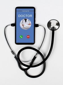 image of mobile phone and doctor on screen