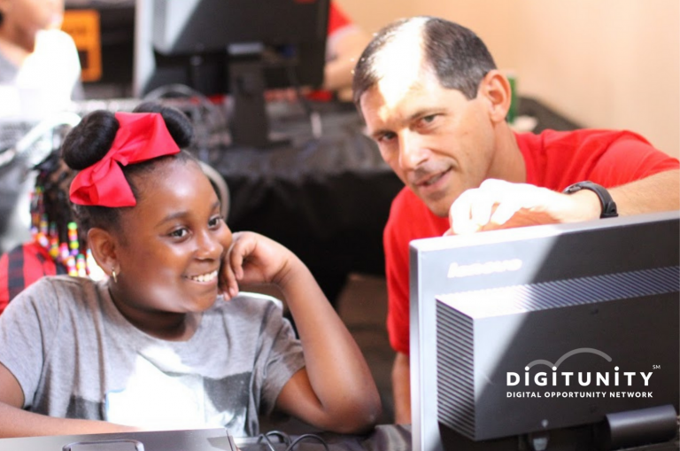 child and teacher at computer